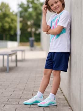 Navy blue athletic mesh shorts and a graphic Messi-branded t-shirt to create a cohesive fan-inspired look.