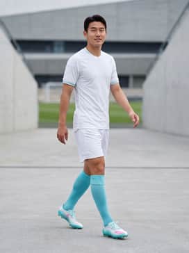 An official match-day kit featuring a white or light blue performance jersey with matching shorts and high-compression team socks for a unified professional appearance.