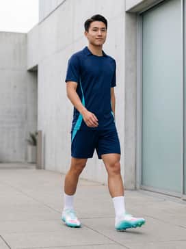 F50 Messi League Firmmultiground Cleats – A professional-grade kit featuring a sleek navy blue moisture-wicking jersey with cyan side panels and matching athletic shorts to draw attention to the shoe's primary base color.