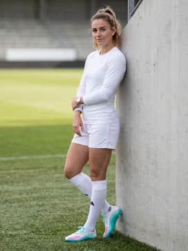 F50 Messi League Firmmultiground Cleats – Classic white soccer socks pulled up to the knee, paired with a clean all-white team uniform that allows the vibrant pink three-stripes and cyan soleplate to stand out on the pitch.