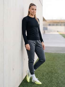 F50 Sparkfusion Elite Mid Cut Firm Ground  Artificial Ground Soccer Cleats Womens – Monochromatic charcoal grey tech-fleece joggers with a tapered ankle and a form-fitting long-sleeve performance top to emphasize the shoe's mid-cut profile.