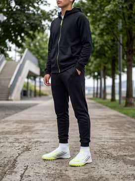 F50 Sparkfusion League Mid Cut Turf Soccer Shoes Kids – Black tapered training joggers paired with a lightweight, breathable zip-up hoodie in a complementary neon yellow or neutral grey.
