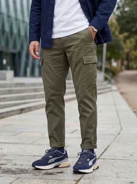 Tapered olive green cargo trousers combined with a crisp white t-shirt and a navy chore coat to balance the shoe's chunky silhouette.