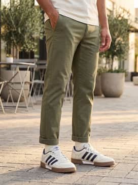 Fechten Indoor Consortium Shoes – Slim-fit olive chinos worn with a tucked-in cream polo shirt and a beige Harrington jacket to highlight the shoe's retro court vibes.