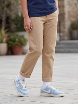 Field General Denim – Style with tan pleated trousers and a tucked-in navy graphic t-shirt to create a balanced contrast between the light blue denim and earthy tones.