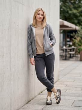 Charcoal fleece joggers with a heathered grey zip-up hoodie and tan crew socks for a coordinated athletic-leisure look.