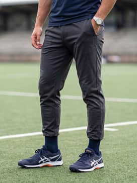 Dark charcoal tapered joggers and a sleek grey quarter-zip pullover for cooler outdoor training sessions.