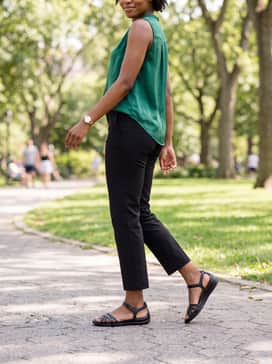 Flash – Black ankle-length tapered trousers combined with a silk sleeveless blouse in a vibrant jewel tone like emerald for a comfortable yet polished office outfit.