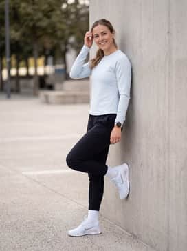 Sleek black tapered joggers and a fitted performance tech-fleece top in a matching pale blue for a streamlined, athletic aesthetic during light training sessions.