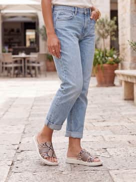 Flowt – Style with light-wash boyfriend jeans rolled at the cuffs, a crisp white button-down shirt, and a stack of gold bangles for an effortless weekend errands look.