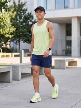Pair with navy moisture-wicking running shorts, a matching lime green performance tank top, and white low-cut athletic socks for a cohesive summer running kit.