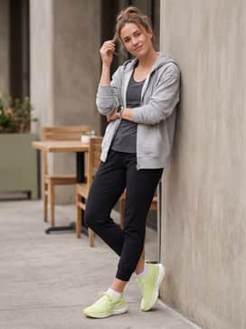 Post-run athleisure: Style with black tapered joggers and a slightly oversized grey zip-up hoodie for a comfortable transition from the track to the coffee shop.
