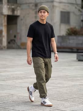 Forum Low Shoes – A pair of relaxed-fit olive cargo pants, a black cropped baby tee, and a matching olive beanie for a utilitarian streetwear aesthetic.