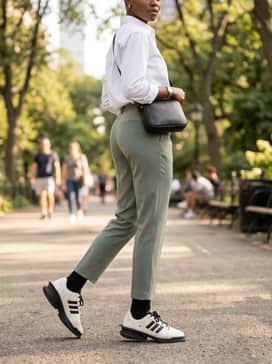 Forum Sq Shoes – Tailored sage green joggers with a crisp white button-down shirt and a minimalist black crossbody bag for a refined athletic-leisure vibe.
