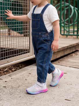For a casual day out, style with denim overalls and a simple white tee, allowing the colorful gradient sole to be the statement piece of the outfit.