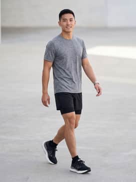 Fresh Foam X 1540 V4 Made In Usa – A high-performance running outfit featuring black 5-inch compression shorts, a heathered grey moisture-wicking tech tee, and black low-cut athletic socks.
