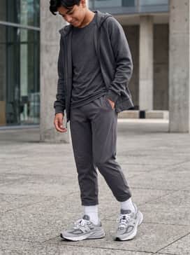 An athletic weekend outfit consisting of tapered charcoal joggers, a moisture-wicking technical t-shirt, and a matching fleece zip-up hoodie for ultimate comfort.