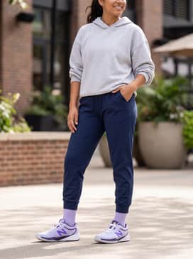 Fuelcell 996v6 – Navy blue high-waisted compression leggings and a light grey oversized hoodie, perfect for transitioning from a morning workout to a casual coffee run.