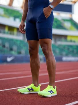 Fuelcell Flites – High-performance aerodynamic look with a navy blue speed suit and sleek athletic sunglasses for a competitive race day.
