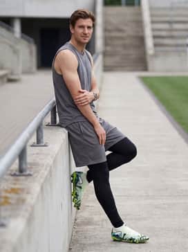 Future 9 Ultimate Creativity Mens Firmartificial Ground Soccer Cleats – A high-intensity warm-up look with black compression leggings under mesh training shorts paired with a sleeveless performance tank in a neutral grey.