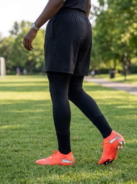 A high-compression base layer shirt worn with breathable mesh training shorts and a moisture-wicking headband for intensive practice.