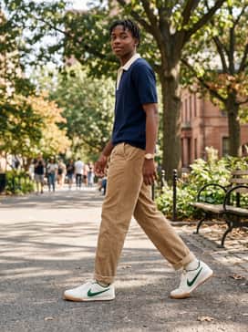 Tan corduroy pants and a navy knit polo shirt for a 'preppy-meets-sporty' vibe that allows the gum sole to blend perfectly with earthy tones.