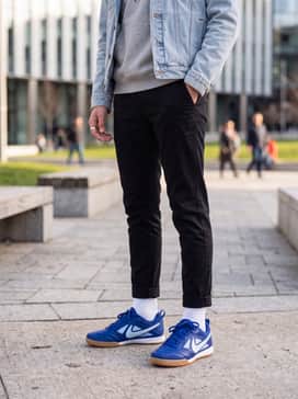 Slim-fit black joggers paired with a heather grey graphic hoodie and a light-wash denim jacket for a layered urban vibe.