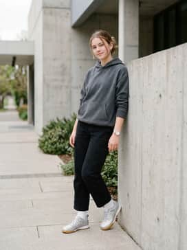Streetwear aesthetic combining black cargo pants, an oversized silver or grey puffer jacket, and a minimalist black beanie to ground the metallic shine.