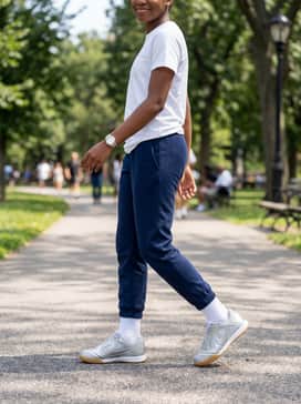 Casual school-ready style with navy blue joggers, a crisp white polo shirt, and a silver-toned watch to echo the footwear's primary color.