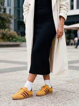 Combine with a black ribbed midi dress and an oversized cream-colored trench coat for a sophisticated yet effortless street-style ensemble.