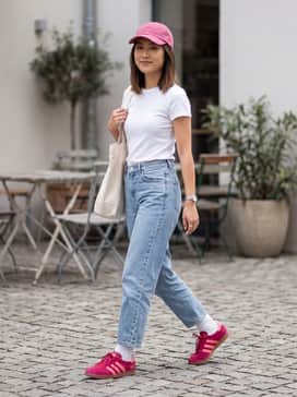 Pair with oversized light-wash denim jeans, a white baby tee, and a matching pink baseball cap for a cohesive 90s-inspired street look.
