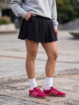Style with a black pleated tennis skirt, a grey heathered crewneck sweatshirt, and chunky white crew socks to highlight the shoe's vibrant color.