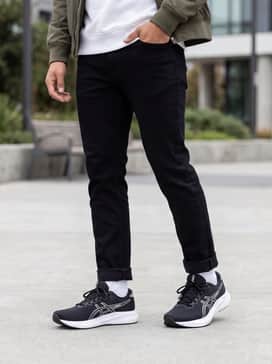 Gelexcite 11 – Classic black slim-fit denim jeans with a crisp white crewneck sweatshirt and a lightweight olive green bomber jacket for a sharp street-casual look.