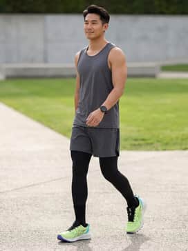 Gelexcite Trail 2 – Black high-performance compression leggings layered under charcoal grey technical running shorts, paired with a moisture-wicking neon lime singlet to mirror the shoe's upper.