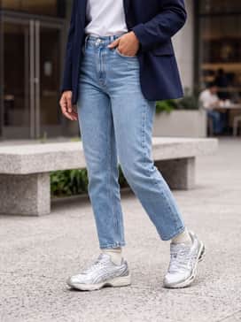 Gelkinetic Fluent – High-waisted straight-leg light-wash denim jeans with a tucked-in white graphic tee and a navy blue oversized blazer for a smart-casual city vibe.