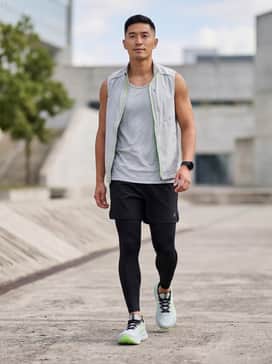 Gelnimbus 28 Extra Wide – A high-performance training kit featuring black compression leggings, a neon green moisture-wicking tank top, and a lightweight grey running vest.