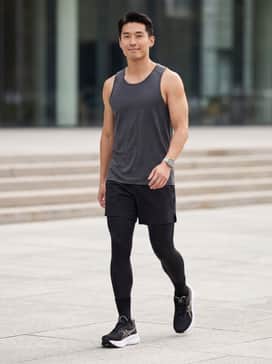 Gelnimbus 28 Extra Wide – A pair of black moisture-wicking 5-inch running shorts matched with a charcoal grey performance tank top and thin technical socks.