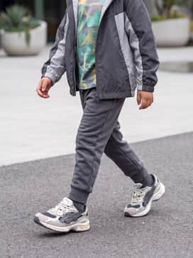 Gelnyc Preschool – A pair of tapered charcoal grey joggers paired with a vibrant graphic t-shirt and a matching lightweight windbreaker for a classic sporty aesthetic.