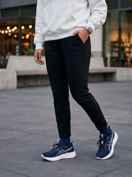 Gelpulse 17 – Black slim-fit joggers and a crisp white oversized hoodie, perfect for a comfortable transition from a workout to a social coffee run.