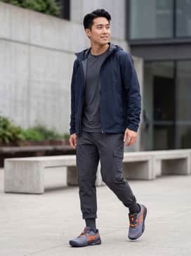 Gelresolution X – A professional on-court look featuring navy blue performance shorts, a breathable white athletic polo with orange accents, and cushioned crew socks.