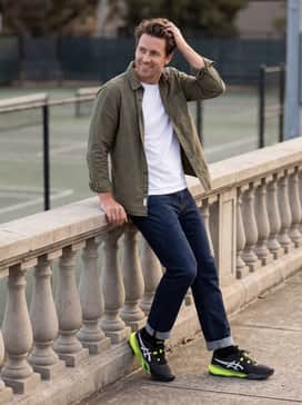 Gelresolution X – Dark-wash straight-leg denim cuffed at the ankle to show off the shoe's profile, styled with a simple white tee and an unbuttoned olive overshirt.