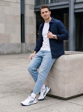 Gelrocket 12 – A relaxed weekend outfit pairing light-wash tapered denim jeans with a simple white graphic t-shirt and an unbuttoned navy overshirt to highlight the sneaker's clean colorway.