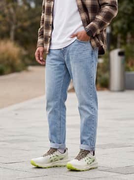 Gelsonoma 8 – Style with light-wash tapered jeans, a crisp white heavyweight t-shirt, and an unbuttoned brown flannel shirt to lean into a rugged urban aesthetic.