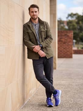 Gelsonoma 8 – Casual weekend attire pairing dark-wash athletic-fit jeans with a heathered grey thermal henley and a rugged olive green field jacket to ground the vibrant shoe color.