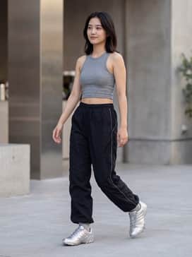 Pair these silver sneakers with loose-fitting black nylon track pants and a fitted grey rib-knit crop top for a sleek, monochromatic Y2K-inspired streetwear look.