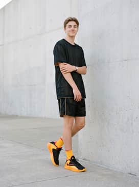 Giannis Freak 7 Ignition – An oversized black graphic streetwear tee worn with loose-fitting nylon utility pants to lean into a bold, urban athletic aesthetic.
