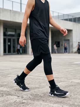 A full basketball kit featuring breathable mesh shorts in a matching black and white colorway and a sleeveless performance jersey.