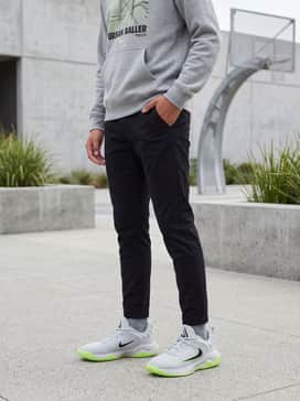 Slim-fit black joggers and an oversized heather grey hoodie with a neon graphic print for a coordinated street look.