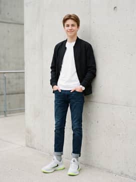 Dark-wash tapered jeans, a basic white tee, and a black bomber jacket to balance the bright accents of the shoe.