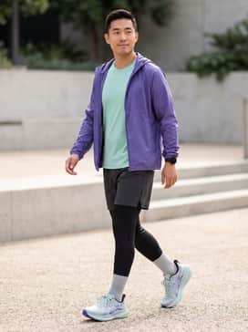 Glideride Max 2 – A performance-focused kit featuring black compression tights, a mint green moisture-wicking technical tee, and a lightweight purple windbreaker to highlight the shoe's accents.
